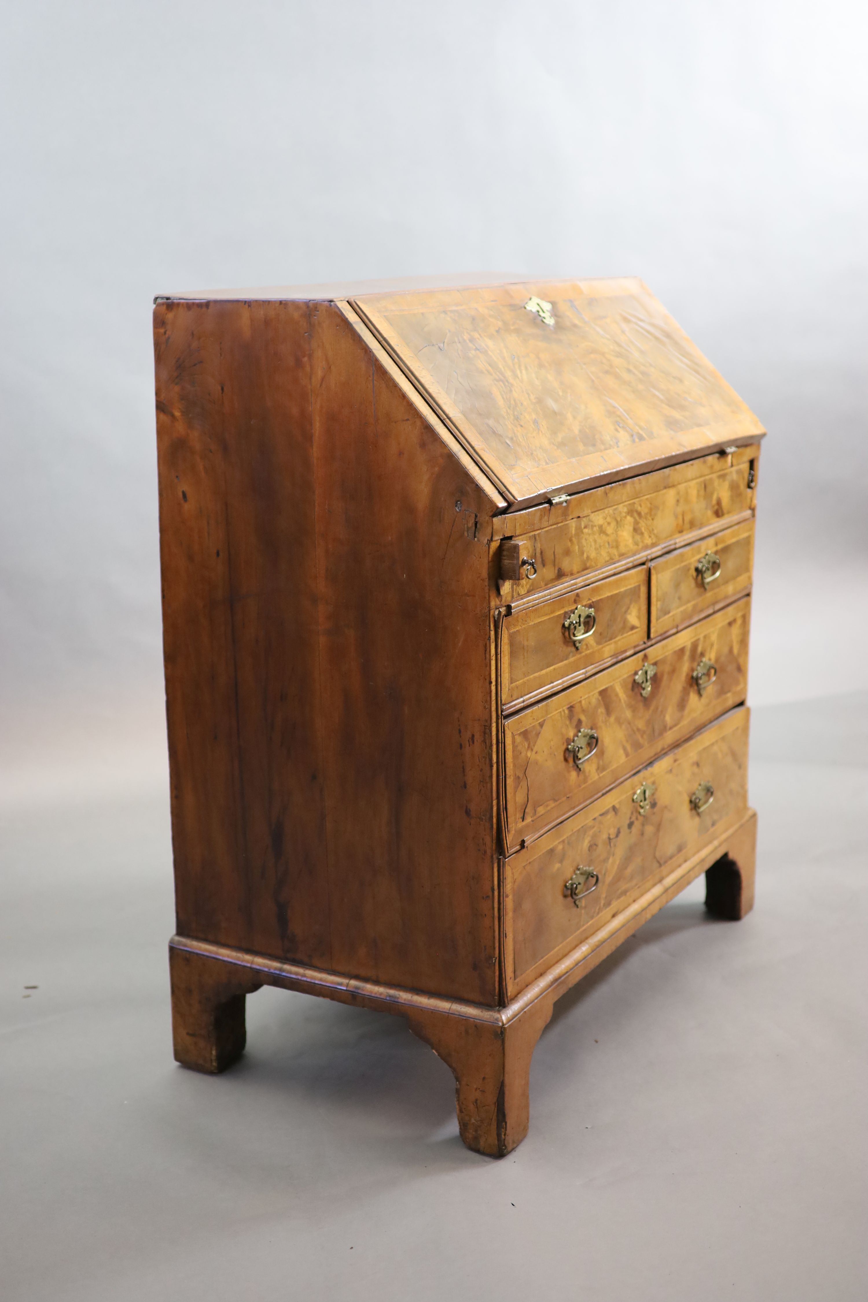 An early 18th century small walnut and crossbanded bureau, width 84cm, depth 46cm, height 98cm